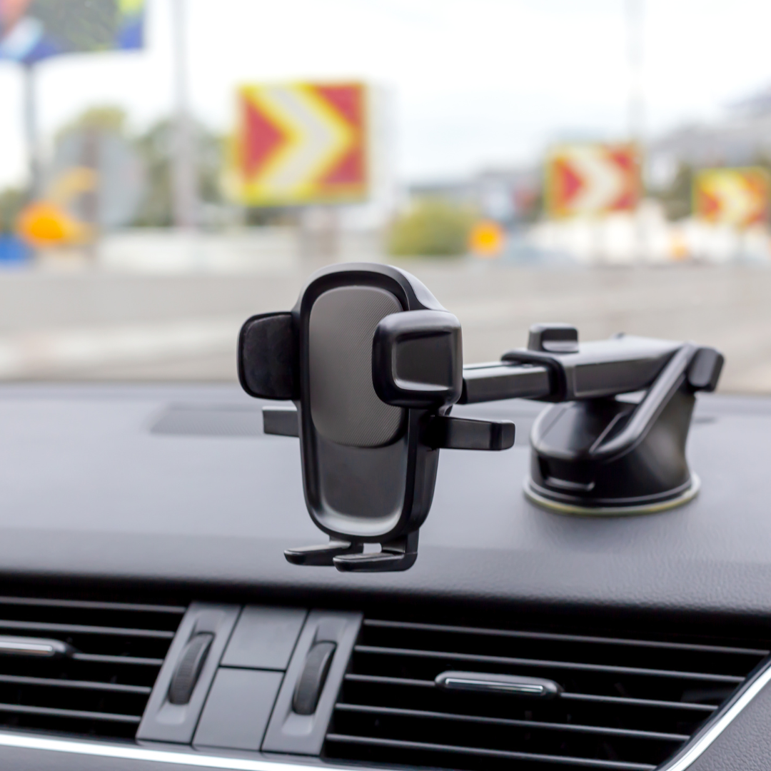Secure and adjustable car phone holder mounted on the dashboard, ideal for hands-free navigation and safe driving.