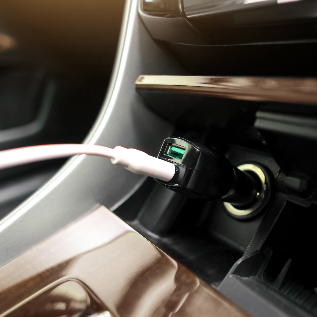 Compact fast-charging USB car charger plugged into a vehicle, supporting QuickCharge and USB-C devices.